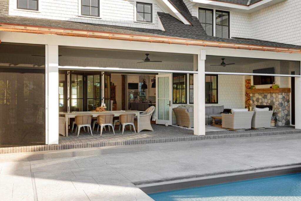 outdoor dining by the pool by konen homes shades