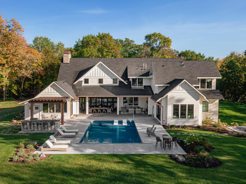 large swimming pool and entertainment area by konen homes